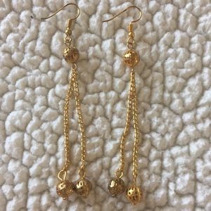 Pair of gold colored earrings